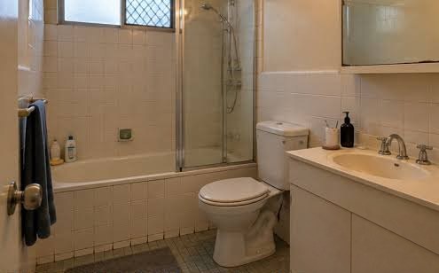 Dated builder-grade bathroom before renovation